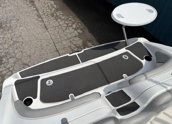 Slide: The Image of 2012 Yamaha AR210 boat deck with seating and a small round table. - 35