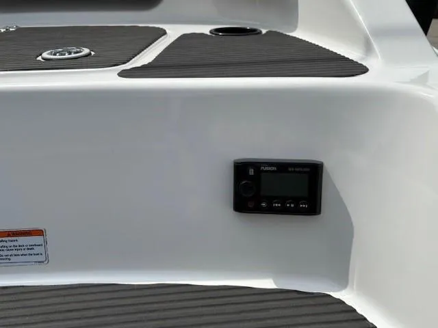 Slide: The Image of 2012 Yamaha AR210 boat dashboard with Fusion stereo system and black non-slip mats. - 36