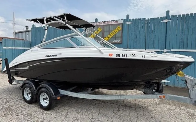 Slide: The Image of 2012 Yamaha AR210 boat on trailer, black and white design, parked outdoors. - 37