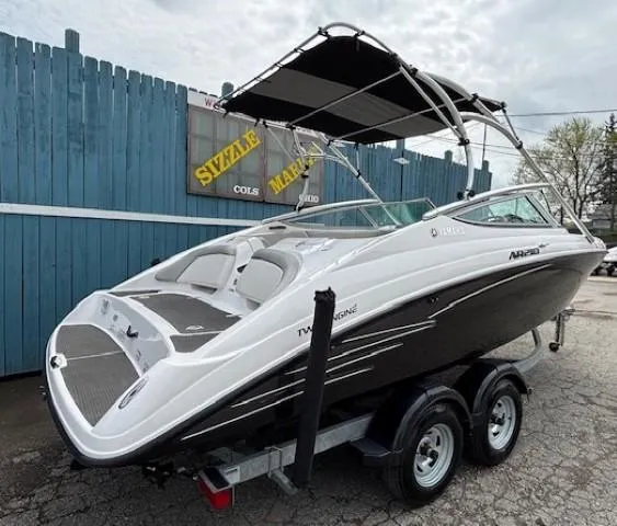Slide: The Image of 2012 Yamaha AR210 boat on trailer, parked near blue fence. - 38