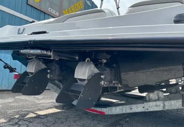 Slide: The Image of 2012 Yamaha AR210 boat stern view with dual jet drives on a trailer. - 6
