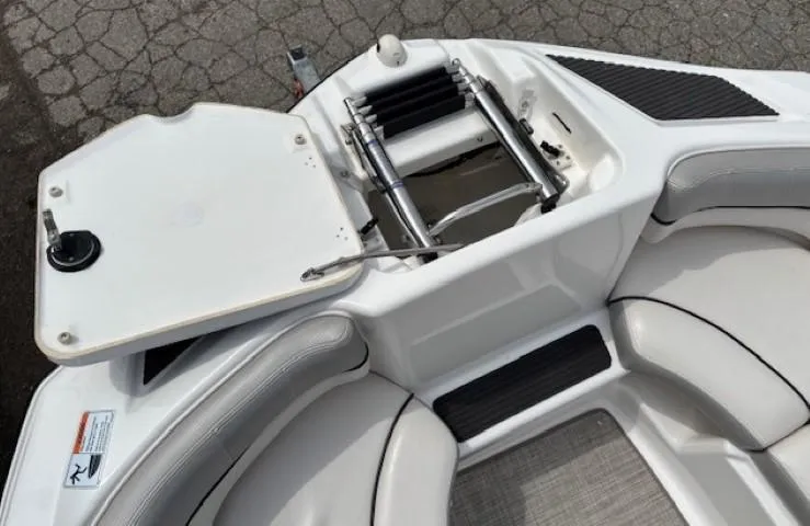 Slide: The Image of 2012 Yamaha AR210 boat interior with open storage compartment and seating. - 8