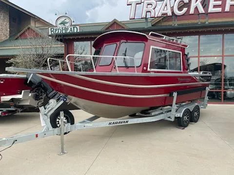 The Image of 2024 Spartan 220 Maximus boat on trailer outside a store. - 1
