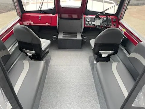Slide: The Image of 2024 Spartan 220 Maximus interior with gray seating and red dashboard. - 5