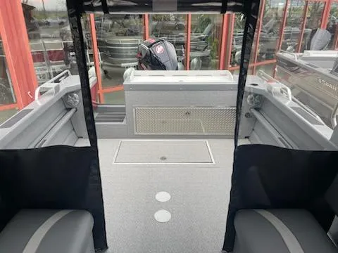 Slide: The Image of 2024 Spartan 220 Maximus boat interior with seating and motor view. - 6