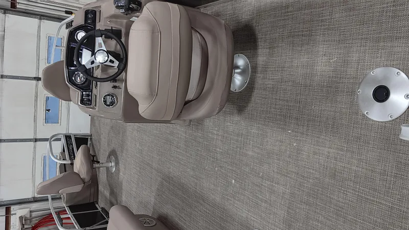 Slide: The Image of 2022 Ranger 200F boat interior with beige seating and steering console. - 10
