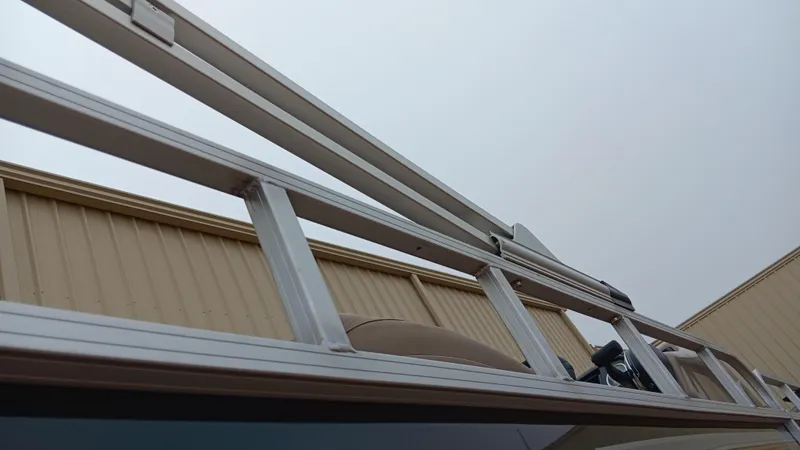 Slide: The Image of Aluminum ladder on a 2022 Ranger 200F boat, against a beige building. - 12