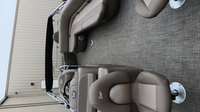 Slide: The Image of 2022 Ranger 200F boat interior with beige seating and carpeted floor. - 21