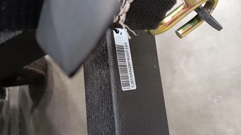 Slide: The Image of Close-up of a 2022 Ranger 200F component with a barcode and metal latch. - 26