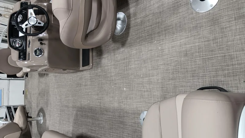 Slide: The Image of Interior of a 2022 Ranger 200F boat with beige seating and steering console. - 7