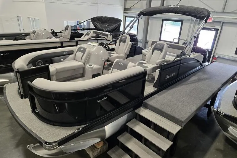 Slide: The Image of 2025 Barletta A22UC pontoon boat with luxurious seating in showroom. - 2