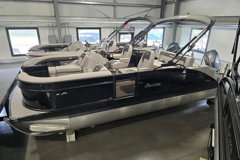 Slide: The Image of 2025 Barletta A22UC pontoon boat in showroom, featuring sleek design and comfortable seating. - 3