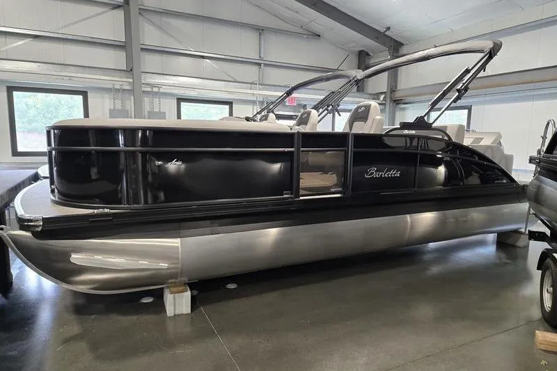 Slide: The Image of 2025 Barletta A22UC pontoon boat in showroom, sleek black design. - 5