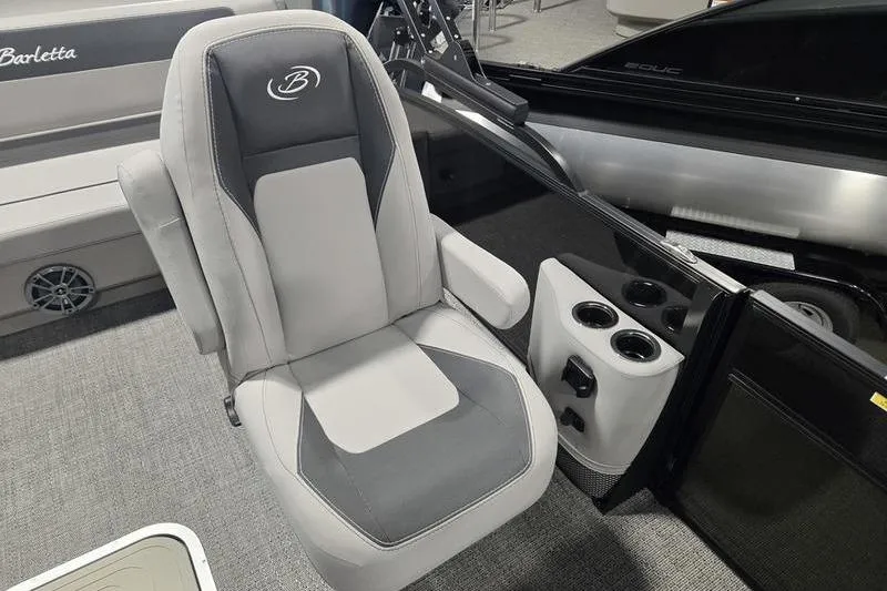 Slide: The Image of 2025 Barletta A22UC boat interior with gray captain's chair and cup holders. - 9
