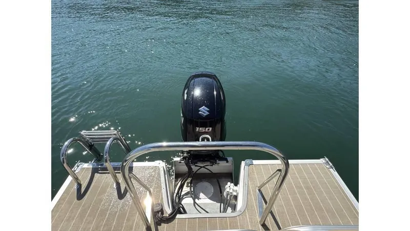 Slide: The Image of 2019 Manitou 23 Aurora LE Bar pontoon boat with Suzuki 150 outboard motor on water. - 3