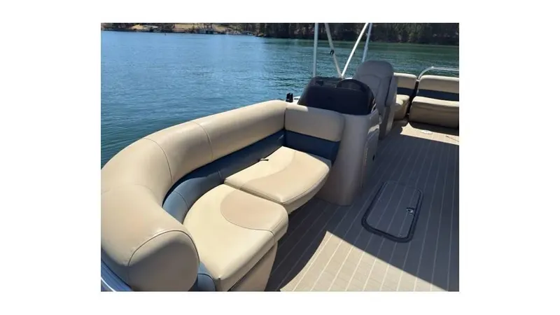 Slide: The Image of 2019 Manitou 23 Aurora LE Bar pontoon boat with beige seating on a calm lake. - 4