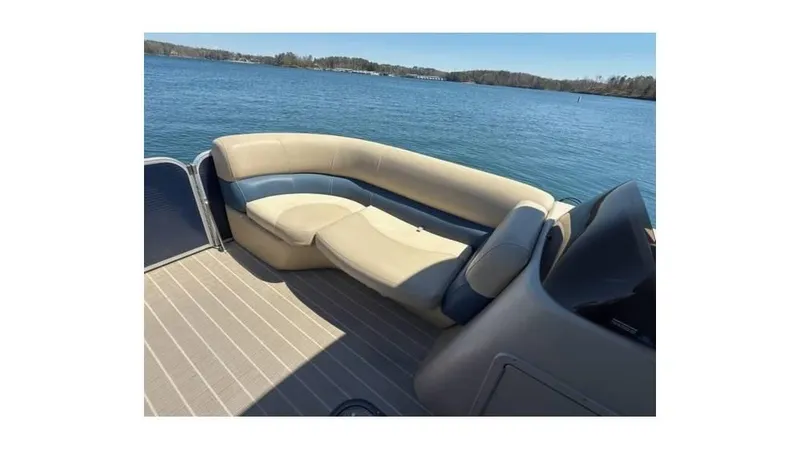 Slide: The Image of 2019 Manitou 23 Aurora LE Bar pontoon boat with beige seating on a lake. - 6