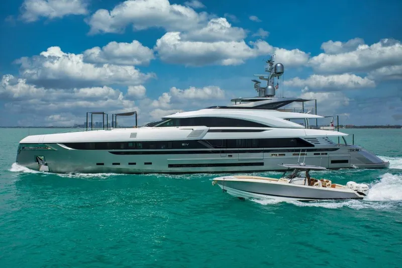 Slide: The Image of Luxurious 2020 Rossinavi Custom yacht cruising alongside a speedboat in turquoise waters. - 16