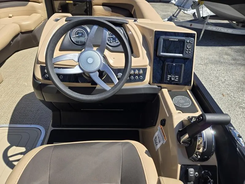 Slide: The Image of 2025 Barletta C22QC boat dashboard with steering wheel and control panel. - 11