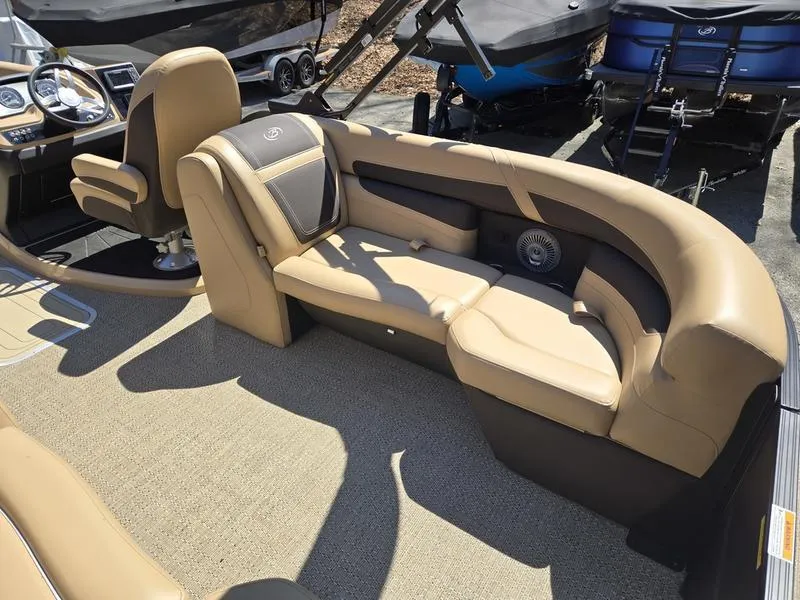 Slide: The Image of 2025 Barletta C22QC boat interior with beige seating and steering console. - 14