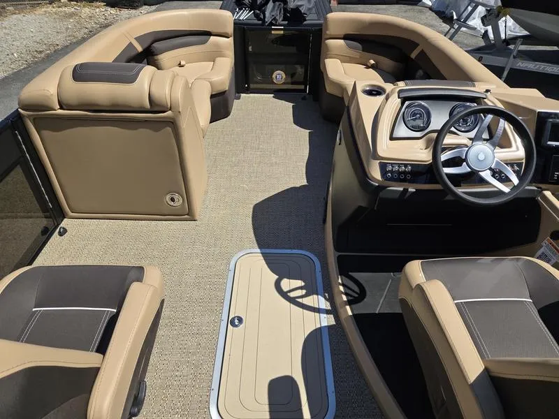 Slide: The Image of 2025 Barletta C22QC boat interior with tan and brown seating, modern dashboard, and spacious layout. - 15