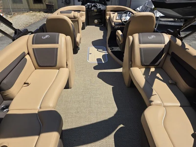 Slide: The Image of 2025 Barletta C22QC pontoon boat interior with tan seating and modern dashboard. - 16