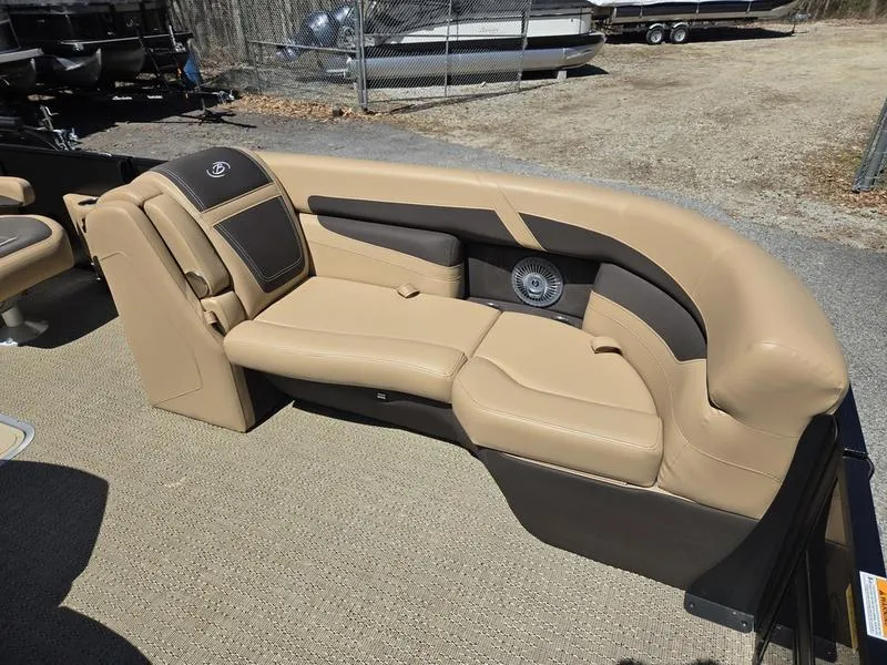 Slide: The Image of 2025 Barletta C22QC boat interior with tan leather seating and speaker system. - 21