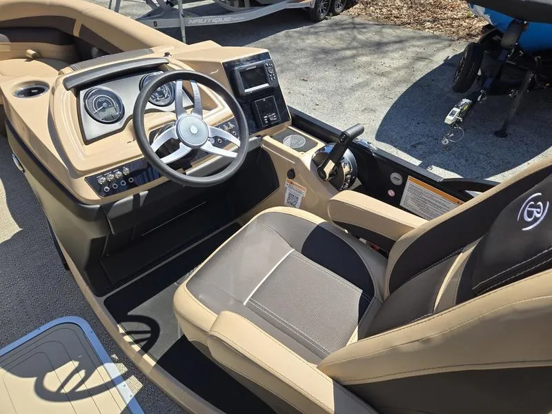 Slide: The Image of 2025 Barletta C22QC boat interior with modern dashboard and comfortable seating. - 9