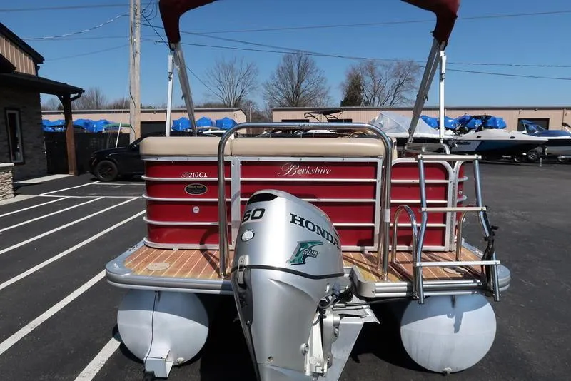 Slide: The Image of 2012 Berkshire G210CL pontoon boat with Honda outboard motor in a parking lot. - 11