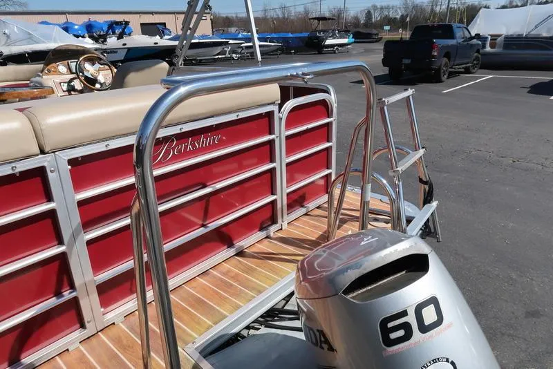 Slide: The Image of 2012 Berkshire G210CL pontoon boat with Honda 60 outboard motor in a parking lot. - 12