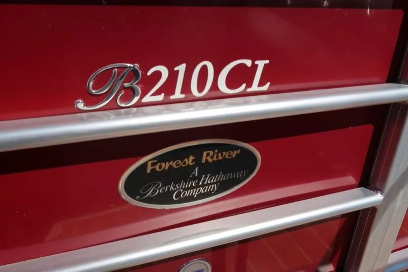 Slide: The Image of Red Berkshire G210CL 2012 model with Forest River logo, Berkshire Hathaway Company. - 13