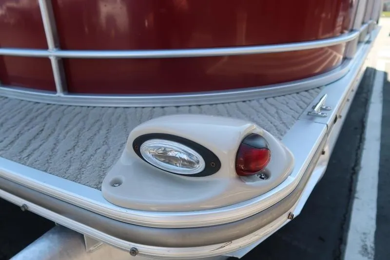 Slide: The Image of 2012 Berkshire G210CL pontoon boat with red exterior and navigation light. - 15
