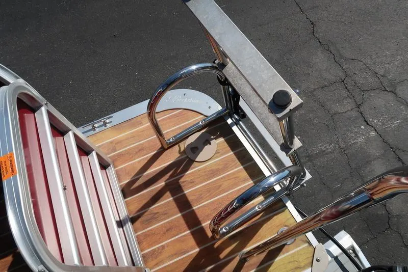 Slide: The Image of Aluminum and wood deck of 2012 Berkshire G210CL boat with metal railings. - 17