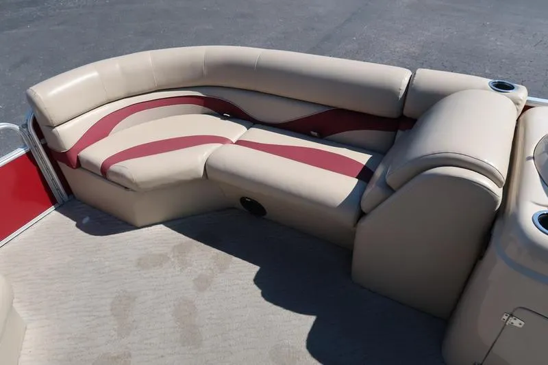 Slide: The Image of 2012 Berkshire G210CL boat seating with beige and red upholstery, featuring cup holders. - 19