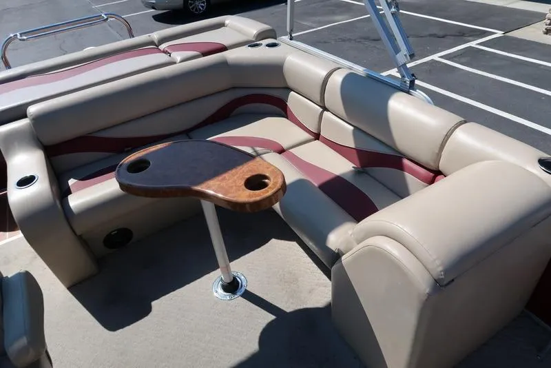 Slide: The Image of Luxurious seating area on a 2012 Berkshire G210CL pontoon boat with a wooden table. - 21