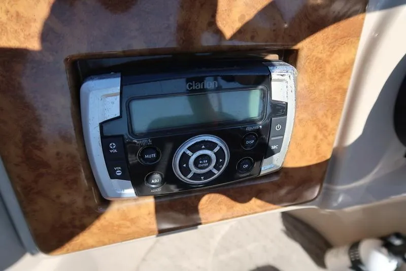 Slide: The Image of Control panel of a 2012 Berkshire G210CL boat with Clarion audio system. - 22