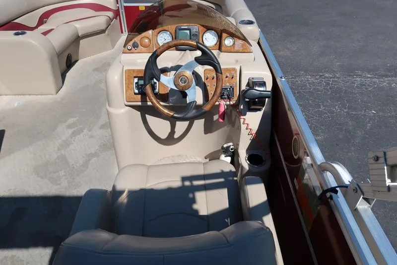 Slide: The Image of 2012 Berkshire G210CL boat cockpit with steering wheel and control panel. - 23
