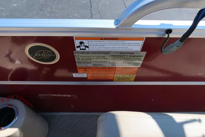 Slide: The Image of 2012 Berkshire G210CL boat interior with warning labels and logo. - 26
