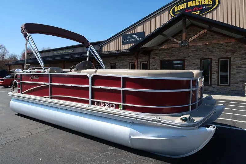 Slide: The Image of 2012 Berkshire G210CL pontoon boat with red exterior, parked outside Boat Masters Marine. - 5
