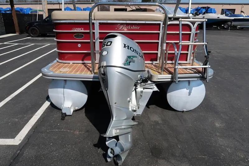 Slide: The Image of 2012 Berkshire G210CL pontoon boat with Honda outboard motor, parked in a lot. - 9