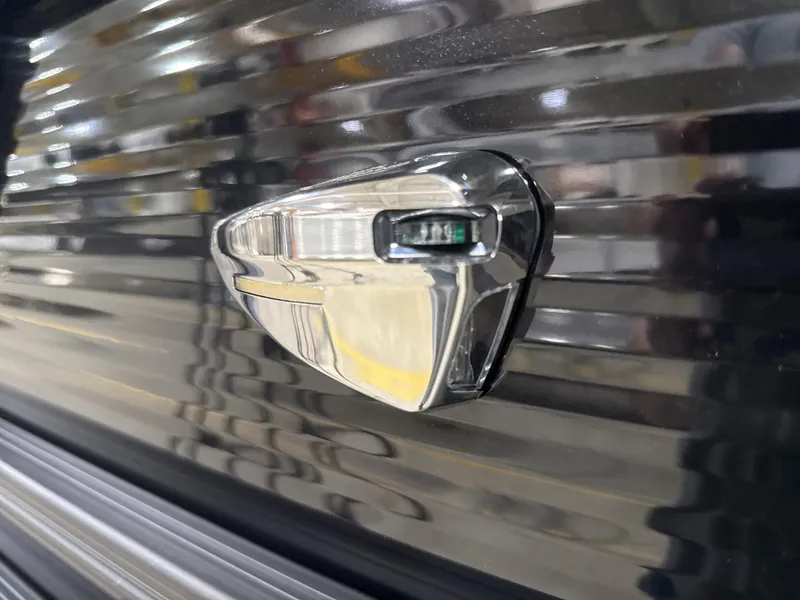 Slide: The Image of 2025 Bennington M Quad Bench 24 MFB, sleek chrome detail on black surface. - 12