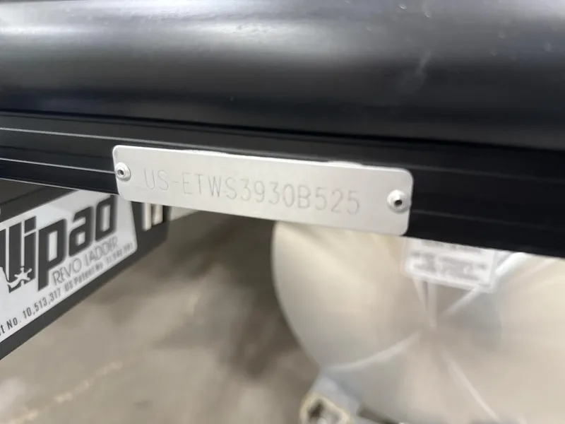 Slide: The Image of 2025 Bennington M Quad Bench 24 MFB with visible serial number plate. - 2