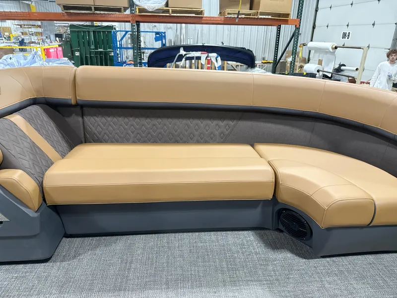 Slide: The Image of 2025 Bennington M Quad Bench 24 MFB with tan and gray upholstery in a warehouse setting. - 3