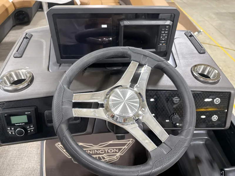 Slide: The Image of Steering console of 2025 Bennington M Quad Bench 24 MFB with modern controls and displays. - 7