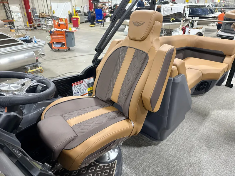 Slide: The Image of Luxurious Bennington M Quad Bench 24 MFB 2025 boat seat in a workshop setting. - 9