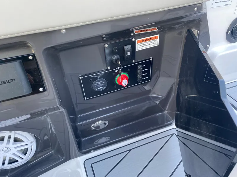 Slide: The Image of 2025 Monterey 278 Super Sport boat control panel with speaker and storage compartment. - 14