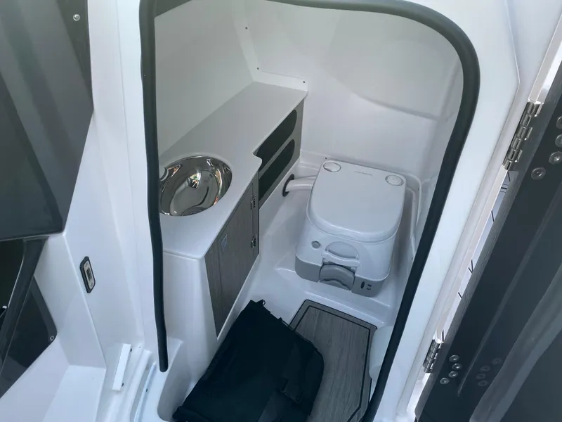 Slide: The Image of 2025 Monterey 278 Super Sport boat interior with compact bathroom and sink. - 19