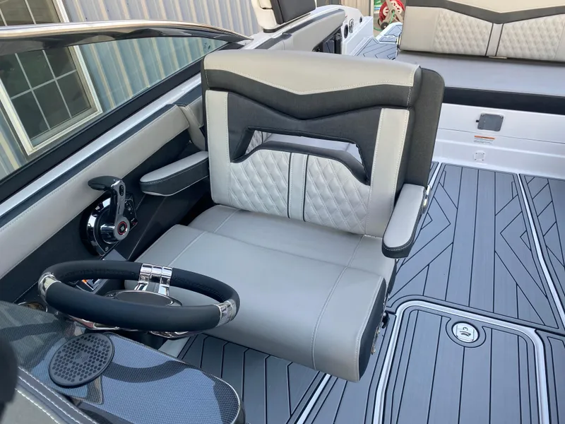 Slide: The Image of 2025 Monterey 278 Super Sport boat interior with modern steering and luxurious seating. - 24