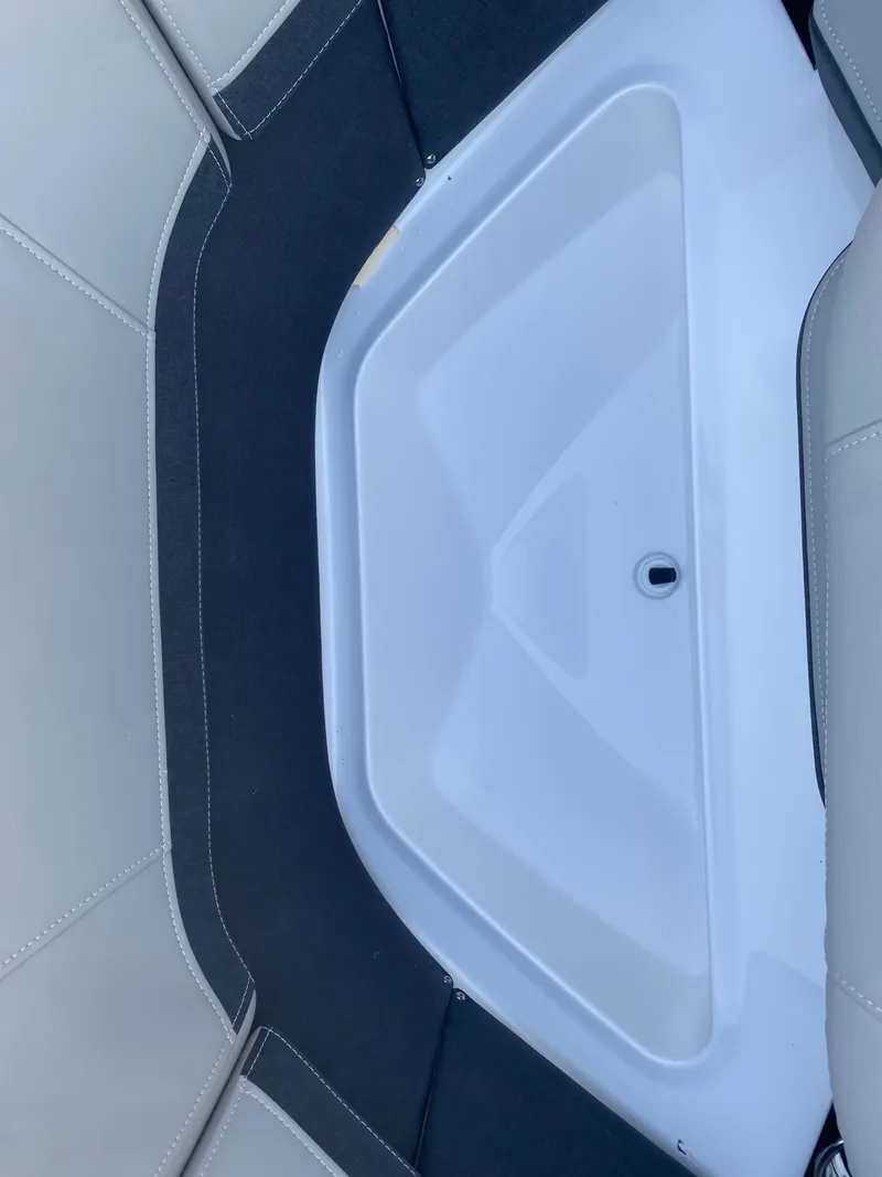 Slide: The Image of 2025 Monterey 278 Super Sport boat interior with sleek seating and storage compartment. - 26