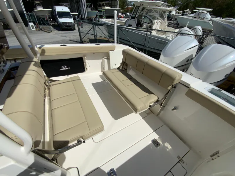 Slide: The Image of 2020 Pursuit S 288 Sport boat with beige seating and dual outboard engines. - 12